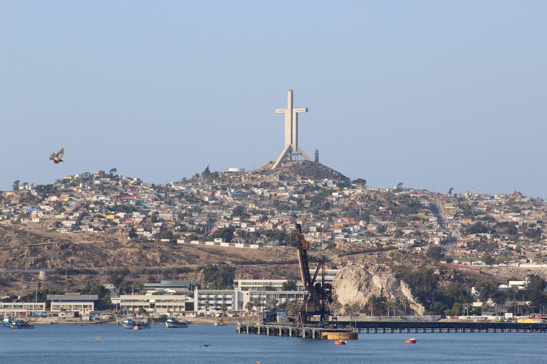 a body of water with a hill in the background